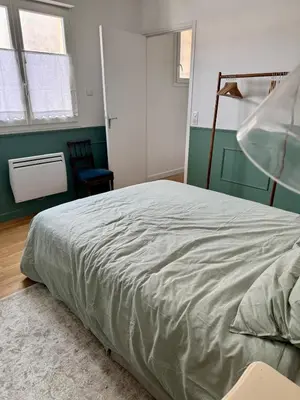 a bedroom with a bed and a green wall at Le Mahuzies 6 - Hypercentre in Castres