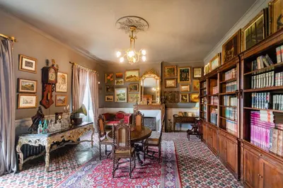 a room with a library with a table and a desk at Château de L'Encastre in Revel