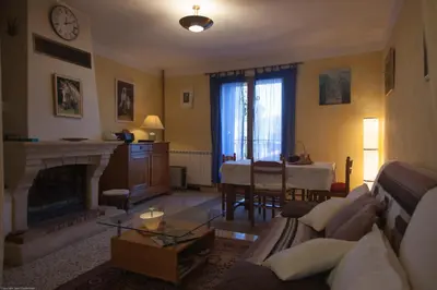 a living room with a couch and a fireplace at Gîte du Four à Chaux in Quillan