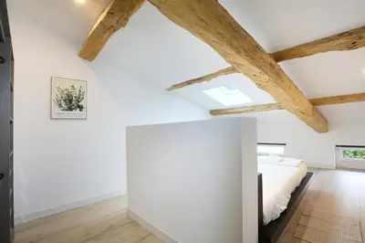 a bedroom with white walls and wooden beams at Confort & espace avec climatisation - T4 central in Villefranche-de-Lauragais