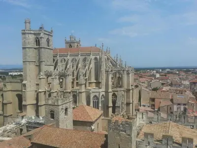 an old church with a view of a city at appartement hyper centre in Narbonne