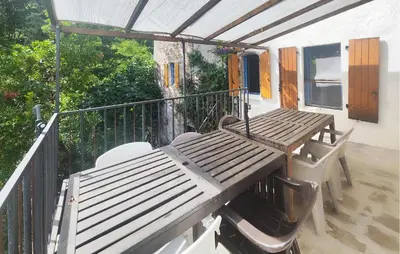 a wooden table and chairs on a balcony at Grande Maison De Village in Saint-Vincent