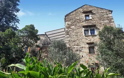 a stone building with a window on the side of it at Grande Maison De Village in Saint-Vincent