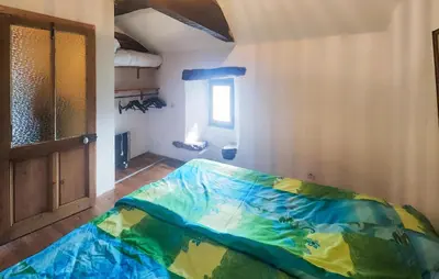 a room with a bed in a room with a window at Grande Maison De Village in Saint-Vincent