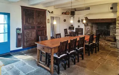 a dining room with a large wooden table and chairs at Grande Maison De Village in Saint-Vincent