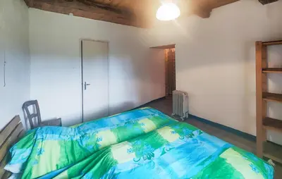 a bedroom with a large bed in a room at Grande Maison De Village in Saint-Vincent