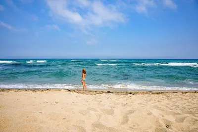 a woman standing on the beach looking at the ocean at Domaine de Puychêne in Saint-Nazaire-dʼAude
