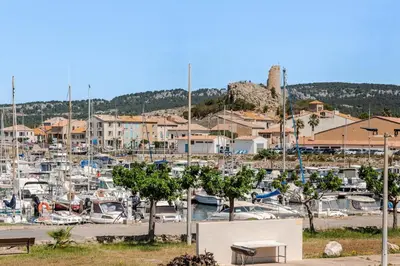 a marina with a bunch of boats in a harbor at Maison Gruissan proche du village et de la plage in Gruissan