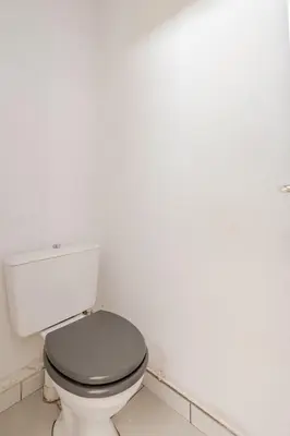 a bathroom with a white toilet in a room at Maison Gruissan proche du village et de la plage in Gruissan