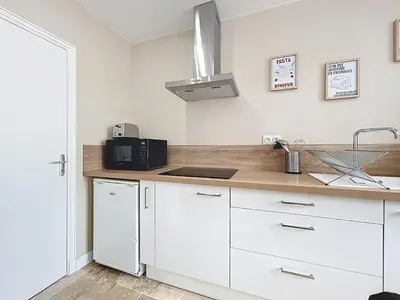 a kitchen with white cabinets and a sink at Lakanaille - Appartement proche du centre - Wifi et Climatisation in Narbonne