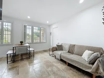 a living room with a couch and a table at Lakanaille - Appartement proche du centre - Wifi et Climatisation in Narbonne