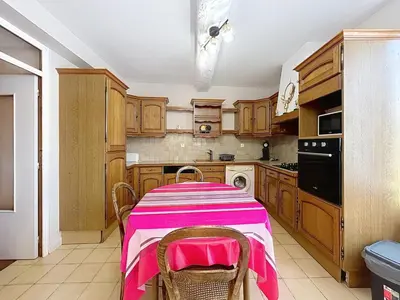 a kitchen with a table with a pink table cloth on it at Le Luxembourg - Appartement proche des Halles - Wifi in Narbonne