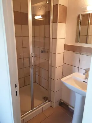 a bathroom with a shower and a sink at Auberge de jeunesse La Forge in Quillan