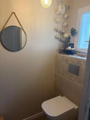 a bathroom with a toilet and a mirror on the wall at Maison 95m2 6 personnes piscine in Narbonne
