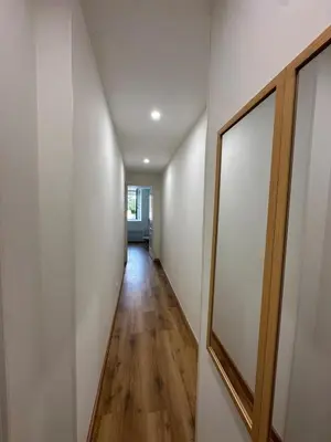 a hallway of a house with white walls and a mirror at Petite maison cosy rénovée, entre mer et vignobles in Ouveillan