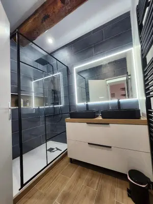 a bathroom with a sink and a mirror at T3 Duplex with bike garage close in Castelnaudary