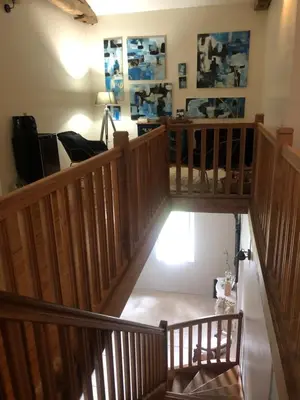 an overhead view of a room with wooden stairs at La Bastide De Negra in Montesquieu-Lauragais