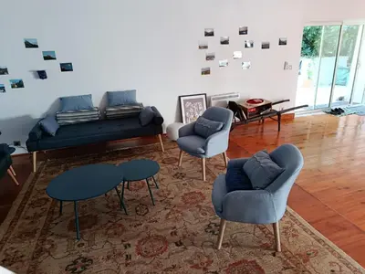 a living room with a couch and chairs and a rug at Proche Carcassone chambre avec salle de bain et WC privée Piscine salon et kitchenette partagés avec voyageurs in Cépie