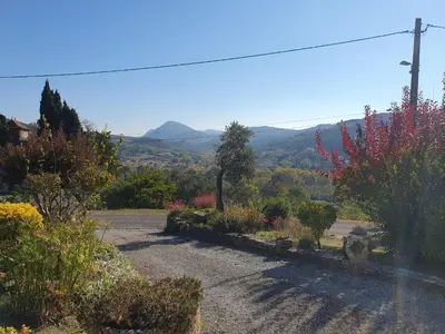 a view of a garden with mountains in the background at Le Gîte Sambacacia in Montazels