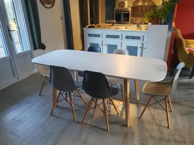 a white table with chairs around it in a kitchen at Le Gîte Sambacacia in Montazels
