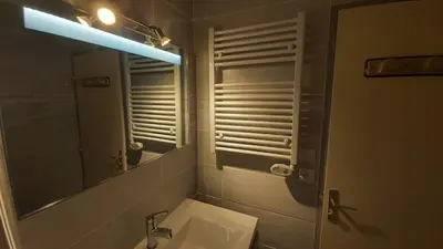 a bathroom with a sink and a mirror at Vagues et Vignes Gruissan Corbières in Gruissan