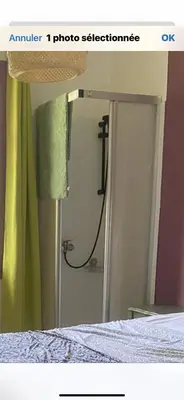 a picture of a bedroom with a bed and a mirror at Hôtel routard in Caudiès-de-Fenouillèdes