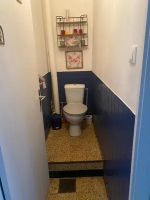 a bathroom with a toilet in a blue tiled bathroom at Hôtel routard in Caudiès-de-Fenouillèdes