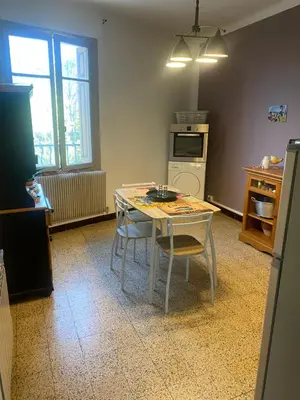 a kitchen with a table and chairs in a room at Hôtel routard in Caudiès-de-Fenouillèdes