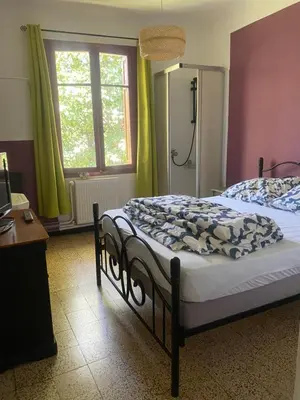 a bedroom with two beds and a window at Hôtel routard in Caudiès-de-Fenouillèdes