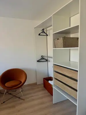 a room with a chair and a closet at Au cœur de l'histoire in Narbonne