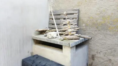 a wall with a shelf with logs and rocks at L'Espert - Appartement avec Terrasse in Gruissan