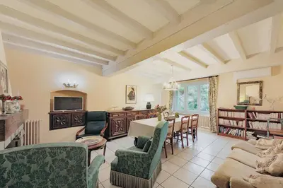 a living room with a table and chairs at Le Refuge du Tarn - Grand Jardin in Puylaurens