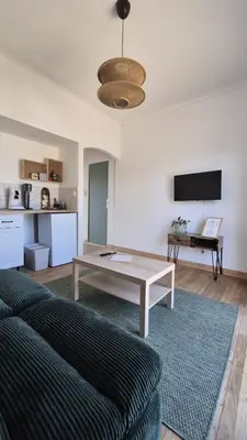 a living room with a couch and a table at Appartement en maison d'hôtes in Badens