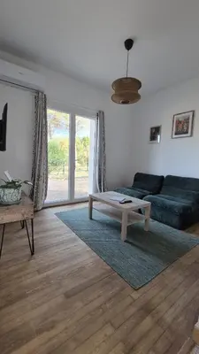 a living room with a couch and a coffee table at Appartement en maison d'hôtes in Badens