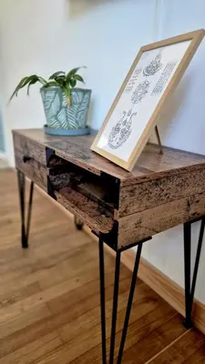 a table with a book and a potted plant on it at Appartement en maison d'hôtes in Badens