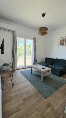 a living room with a couch and a coffee table at Appartement en maison d'hôtes in Badens
