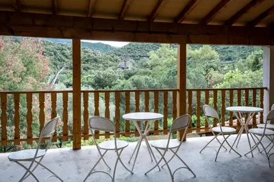 a balcony with tables and chairs and a view of a mountain at Mas Les Albas in Felluns
