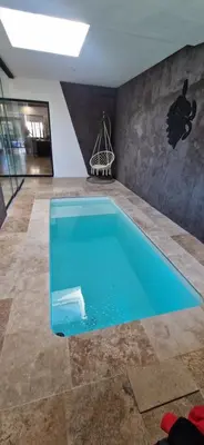 a large swimming pool in a room with at villa proche carcassonne avec piscine chauffée intérieur in Villesequelande