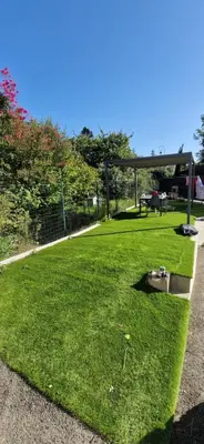 a grassy area with a picnic table in a park at villa proche carcassonne avec piscine chauffée intérieur in Villesequelande