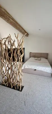 a bedroom with a bed made out of antlers at villa proche carcassonne avec piscine chauffée intérieur in Villesequelande