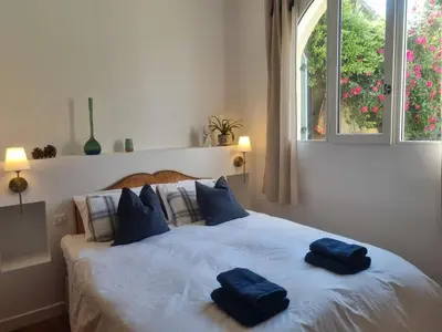 two towels on a bed in a bedroom with a window at Maison Barbaira