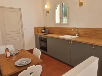 a kitchen with a table and a sink and a counter at Maison Barbaira