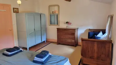 a bedroom with a bed and a dresser and a mirror at Maison Barbaira