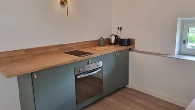 a kitchen with a counter top and a stove at Maison Barbaira