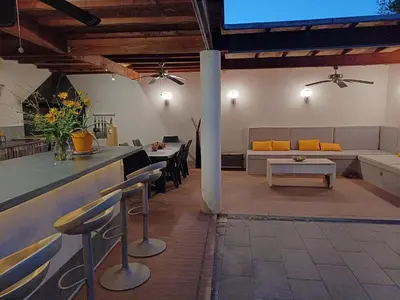 a living room with a couch and a table at Villa d'architecte avec piscine chauffée, 4 chambres, à 30 mn Gruissan plage in Sallèles-dʼAude