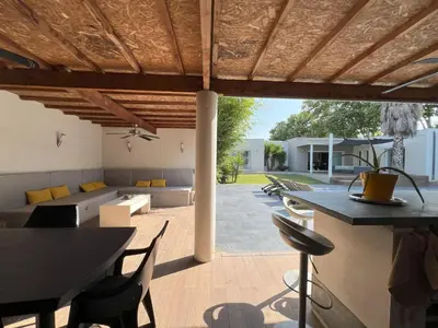 an outdoor patio with a table and chairs at Villa d'architecte avec piscine chauffée, 4 chambres, à 30 mn Gruissan plage in Sallèles-dʼAude