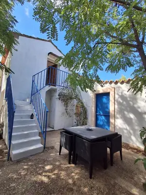 a ping pong table in front of a house with a staircase at Appartement Atypique Corbières in Montséret