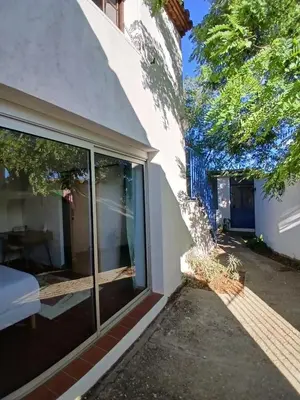 a sliding glass door on the side of a house at Appartement Atypique Corbières in Montséret