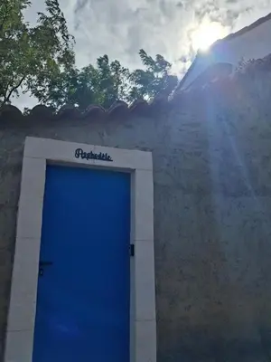 a blue door on the side of a building at Appartement Atypique Corbières in Montséret