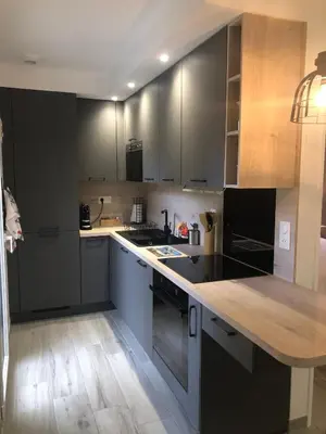 a kitchen with black cabinets and a wooden counter top at Maison d'hôtes à Castres-Saïx in Saix